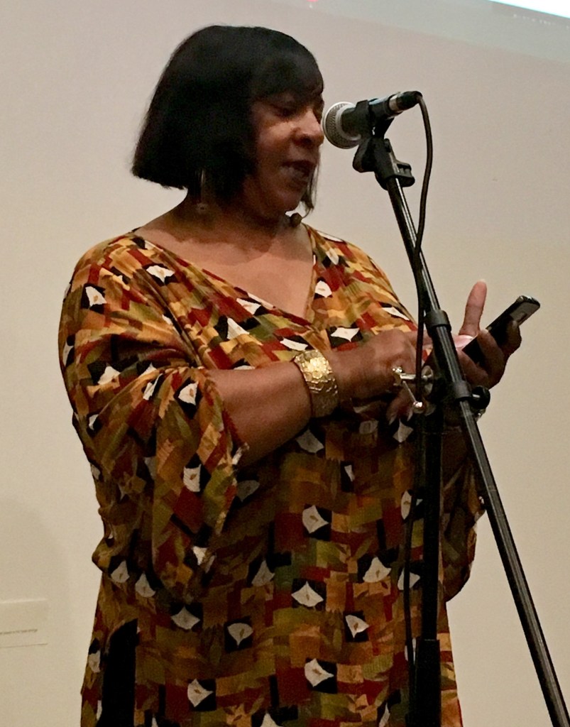 Dera R. Williams, author, writer, Griot reads from her cell phone for Litquake Lit Crawl 2018